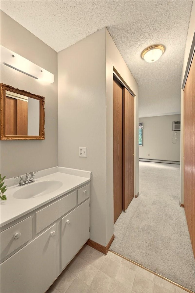 5645 Green Circle Dr Unit 210, Minnetonka, MN 55343 - bathroom with vanity, a textured ceiling, a baseboard heating unit, and a wall mounted AC