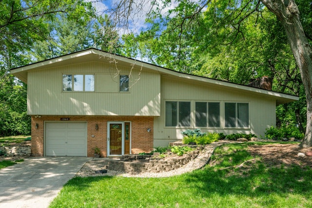 15812 Woodgate Rd N, Minnetonka, MN 55345 - tri-level home featuring brick siding, a garage, a chimney, and driveway