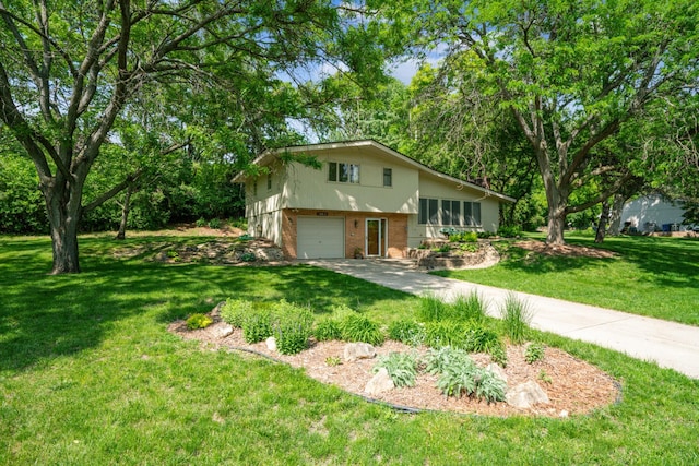 15812 Woodgate Rd N, Minnetonka, MN 55345 - split level home with brick siding, an attached garage, a front lawn, and driveway