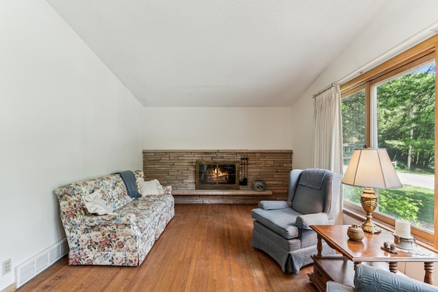 15812 Woodgate Rd N, Minnetonka, MN 55345 - living room featuring a stone fireplace, hardwood / wood-style floors, and vaulted ceiling
