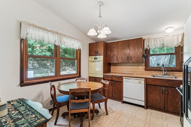 15812 Woodgate Rd N, Minnetonka, MN 55345 - kitchen featuring white appliances, a sink, a chandelier, healthy amount of natural light, and vaulted ceiling