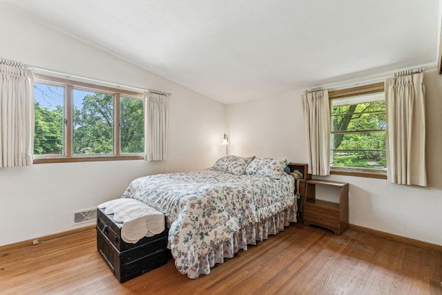 15812 Woodgate Rd N, Minnetonka, MN 55345 - bedroom featuring wood finished floors, lofted ceiling, and baseboards