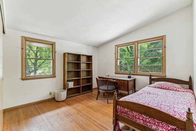 15812 Woodgate Rd N, Minnetonka, MN 55345 - bedroom featuring vaulted ceiling, multiple windows, light wood-style flooring, and baseboards