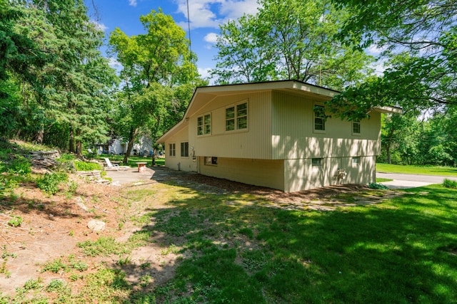 15812 Woodgate Rd N, Minnetonka, MN 55345 - view of home's exterior with a lawn