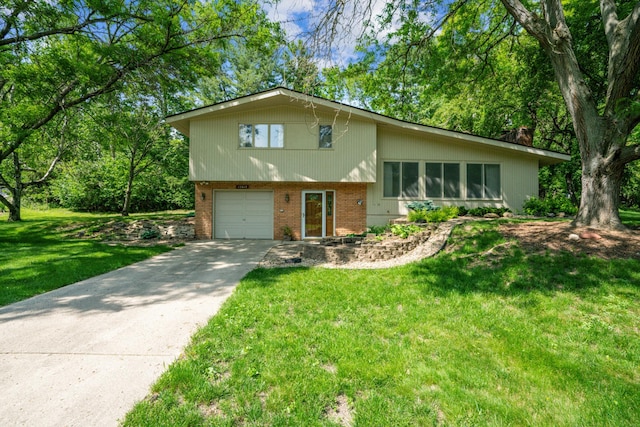 15812 Woodgate Rd N, Minnetonka, MN 55345 - split level home with an attached garage, brick siding, driveway, and a front yard