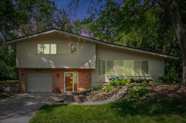 15812 Woodgate Rd N, Minnetonka, MN 55345 - split level home with an attached garage, brick siding, driveway, and a chimney