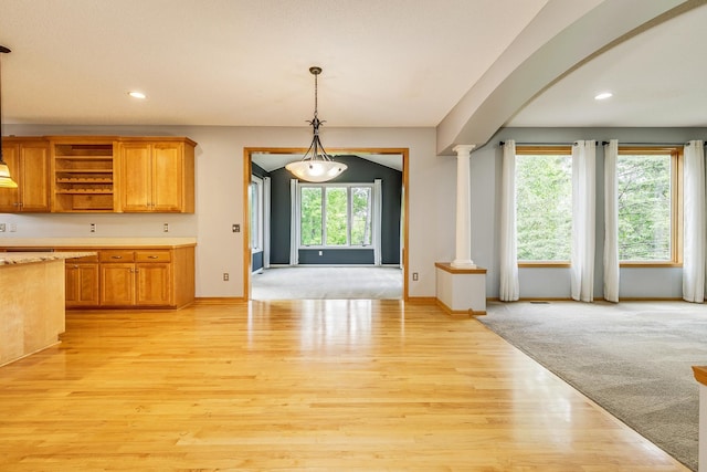 1469 Sherman Lake Rd, Lino Lakes, MN 55038 - kitchen with ornate columns, light countertops, open shelves, light wood-type flooring, and pendant lighting