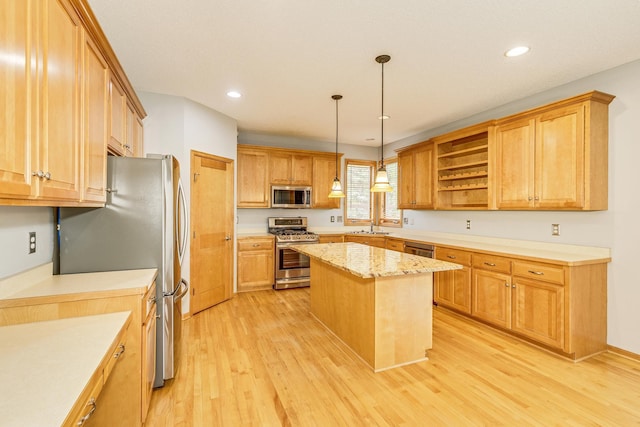 1469 Sherman Lake Rd, Lino Lakes, MN 55038 - kitchen with appliances with stainless steel finishes, light wood-style floors, a center island, pendant lighting, and open shelves