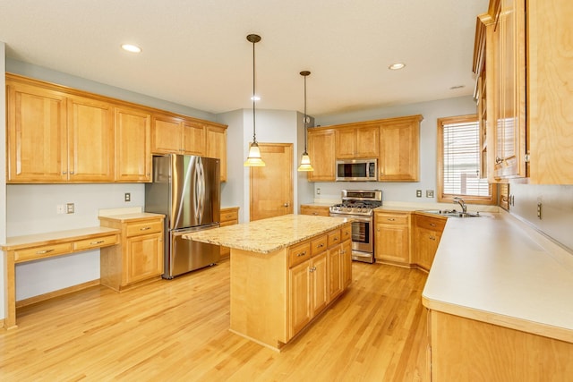 1469 Sherman Lake Rd, Lino Lakes, MN 55038 - kitchen featuring appliances with stainless steel finishes, a kitchen island, light wood finished floors, a sink, and recessed lighting