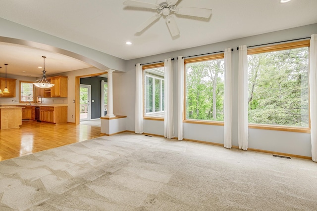 1469 Sherman Lake Rd, Lino Lakes, MN 55038 - unfurnished living room featuring light carpet, arched walkways, recessed lighting, baseboards, and ceiling fan