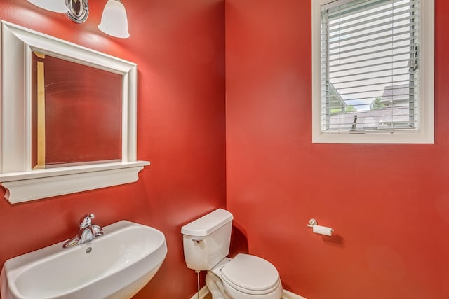 1469 Sherman Lake Rd, Lino Lakes, MN 55038 - bathroom with a sink, toilet, and baseboards