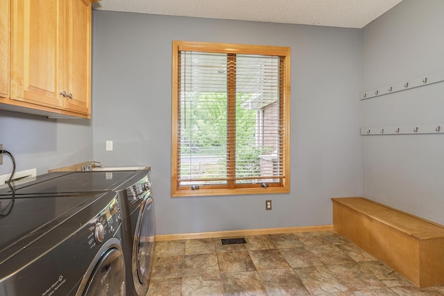 1469 Sherman Lake Rd, Lino Lakes, MN 55038 - laundry room featuring cabinet space, independent washer and dryer, healthy amount of natural light, and baseboards