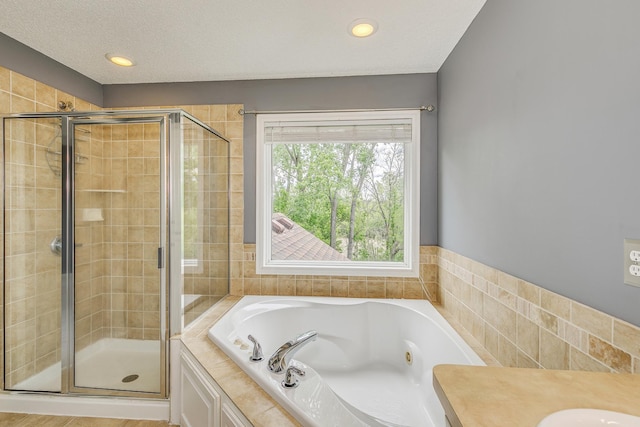 1469 Sherman Lake Rd, Lino Lakes, MN 55038 - bathroom featuring a stall shower, a tub with jets, recessed lighting, and vanity