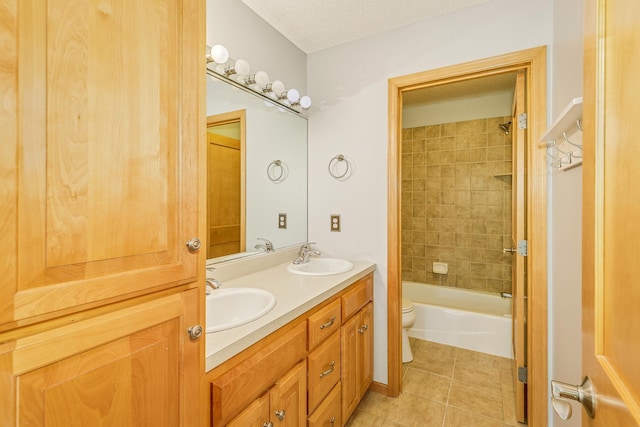 1469 Sherman Lake Rd, Lino Lakes, MN 55038 - bathroom with double vanity, toilet, tile patterned flooring, shower / washtub combination, and a textured ceiling