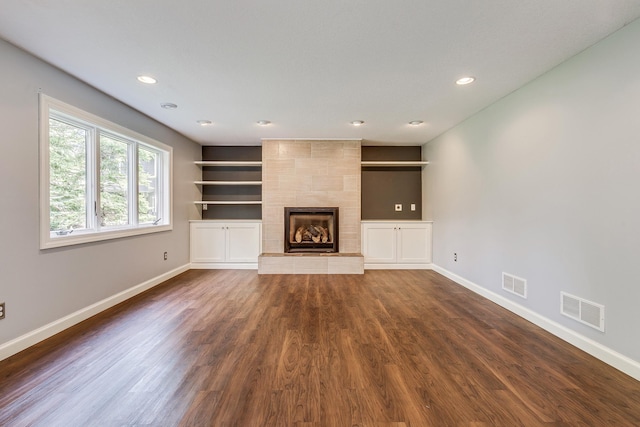 1469 Sherman Lake Rd, Lino Lakes, MN 55038 - unfurnished living room with baseboards, dark wood-style floors, recessed lighting, a fireplace, and built in shelves