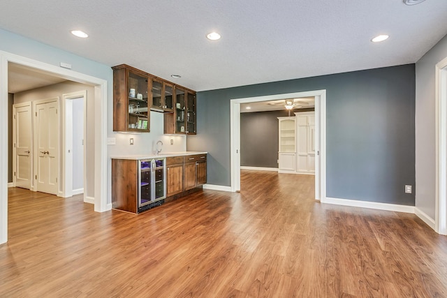 1469 Sherman Lake Rd, Lino Lakes, MN 55038 - indoor wet bar with beverage cooler, baseboards, wood finished floors, and recessed lighting