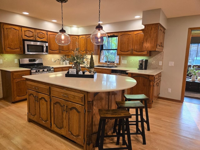 1410 16th St SW, Willmar, MN 56201 - kitchen with appliances with stainless steel finishes, light wood-style floors, a sink, light countertops, and recessed lighting