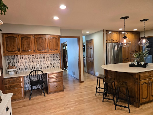 1410 16th St SW, Willmar, MN 56201 - kitchen with freestanding refrigerator, light countertops, recessed lighting, light wood finished floors, and tasteful backsplash