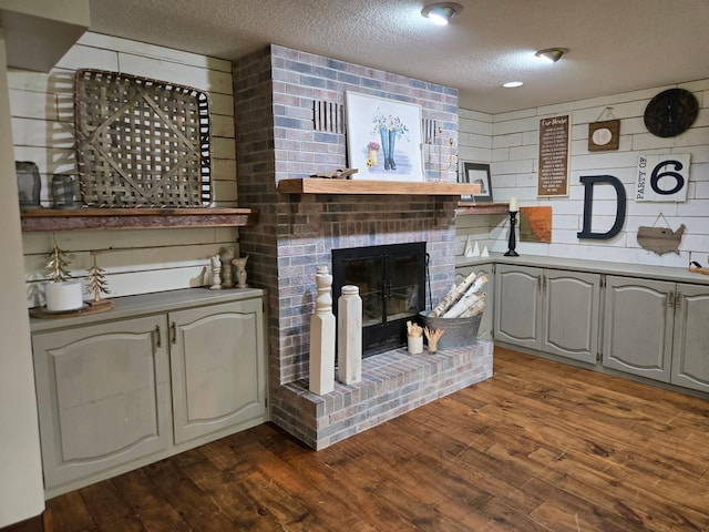 1410 16th St SW, Willmar, MN 56201 - living area with a brick fireplace, dark wood-type flooring, and a textured ceiling