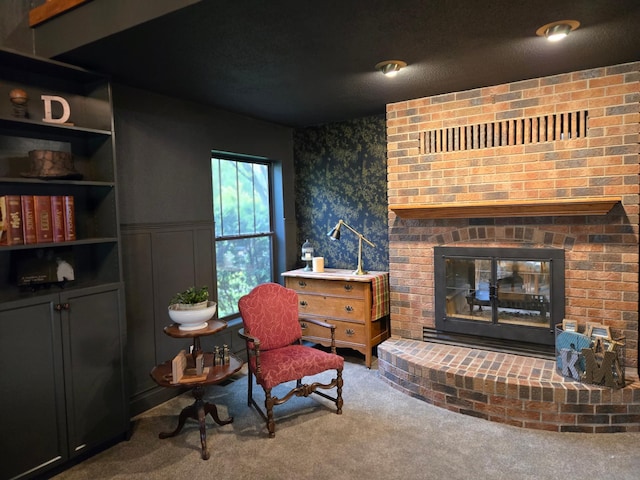 1410 16th St SW, Willmar, MN 56201 - carpeted living room featuring a fireplace, wainscoting, and wallpapered walls
