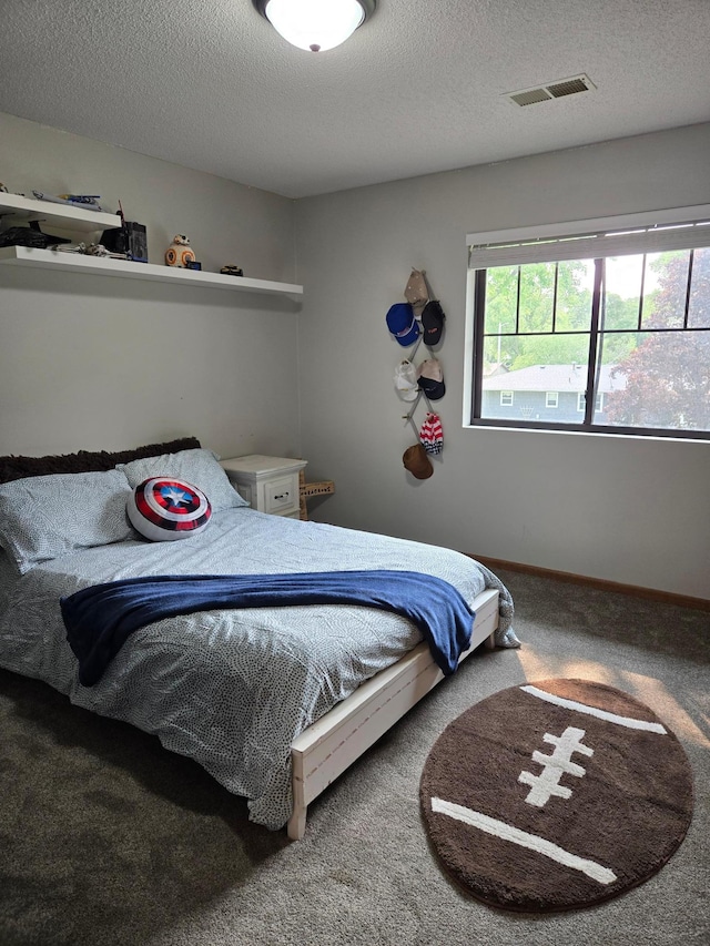 1410 16th St SW, Willmar, MN 56201 - carpeted bedroom with a textured ceiling and baseboards