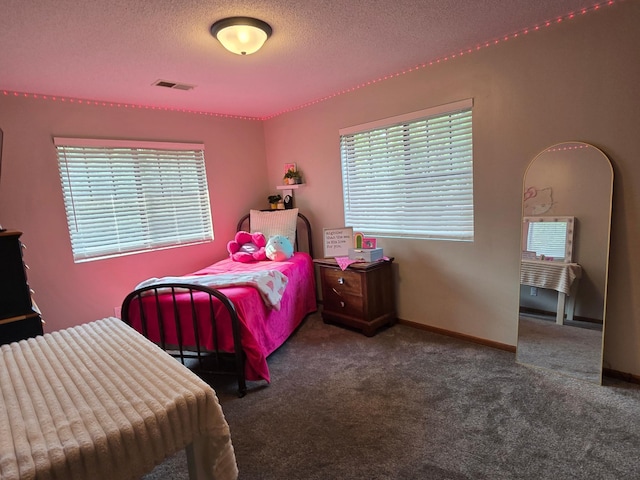1410 16th St SW, Willmar, MN 56201 - carpeted bedroom with a textured ceiling and baseboards