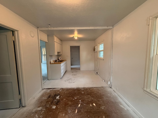 139 Petrick St, Appleton, MN 56208 - kitchen featuring white cabinets and a wall mounted air conditioner