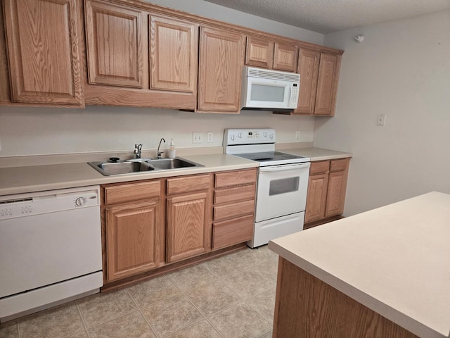 15631 Linnet St NW Unit 3-208, Andover, MN 55304 - kitchen featuring white appliances, a sink, light countertops, and a textured ceiling