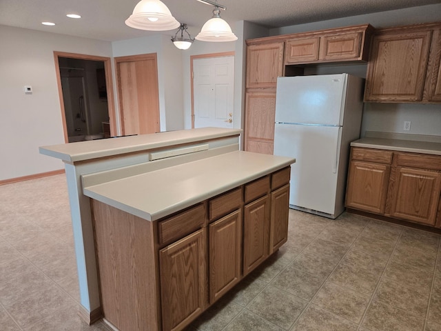 15631 Linnet St NW Unit 3-208, Andover, MN 55304 - kitchen featuring freestanding refrigerator, a center island, light countertops, recessed lighting, and brown cabinetry