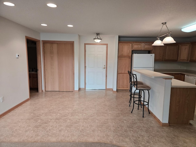 15631 Linnet St NW Unit 3-208, Andover, MN 55304 - kitchen featuring a breakfast bar, white appliances, recessed lighting, baseboards, and hanging light fixtures