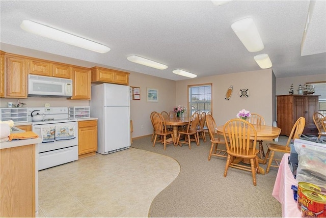 15631 Linnet St NW Unit 3-208, Andover, MN 55304 - kitchen featuring white appliances, light countertops, and a textured ceiling