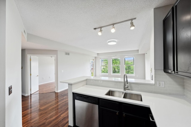 615 1st St Unit 405, Minneapolis, MN 55401 - kitchen featuring stainless steel dishwasher, a sink, dark cabinets, light countertops, and a textured ceiling