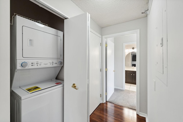 615 1st St Unit 405, Minneapolis, MN 55401 - washroom with estacked washer and dryer, wood finished floors, and a textured ceiling