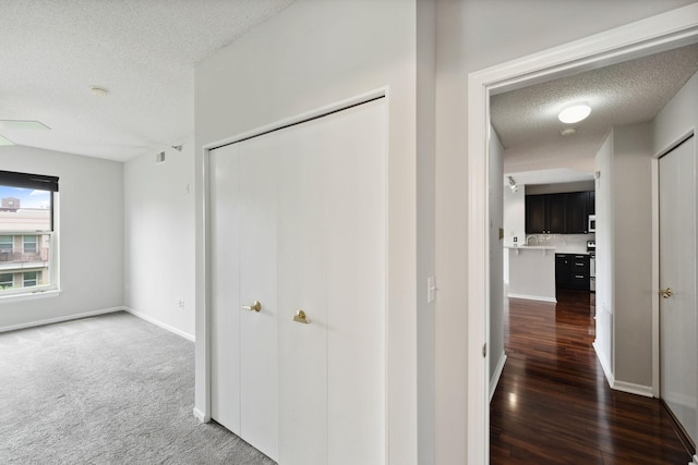 615 1st St Unit 405, Minneapolis, MN 55401 - hall with a textured ceiling, baseboards, and wood finished floors