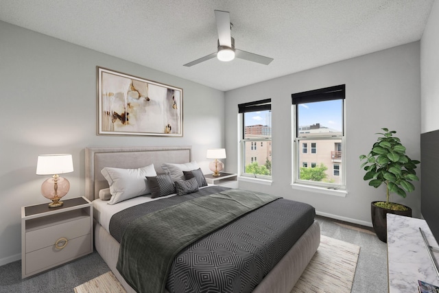615 1st St Unit 405, Minneapolis, MN 55401 - bedroom featuring carpet flooring, baseboards, ceiling fan, and a textured ceiling