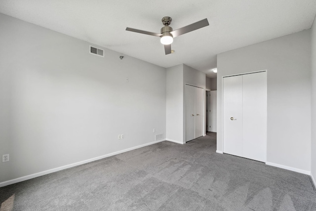 615 1st St Unit 405, Minneapolis, MN 55401 - unfurnished bedroom with carpet flooring, baseboards, two closets, and a ceiling fan
