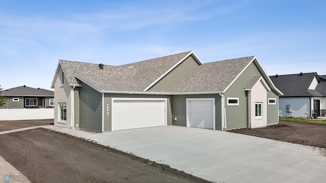 4295 Bristlecone Loop S, Fargo, ND 58104 - view of front of property featuring an attached garage, a shingled roof, and concrete driveway