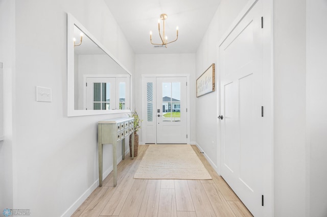 4295 Bristlecone Loop S, Fargo, ND 58104 - doorway with a chandelier, light wood-style flooring, and baseboards