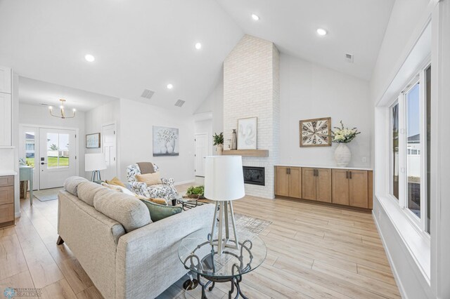4295 Bristlecone Loop S, Fargo, ND 58104 - living room featuring light wood-style flooring, high vaulted ceiling, a fireplace, a chandelier, and recessed lighting