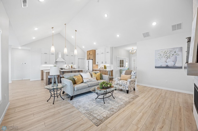 4295 Bristlecone Loop S, Fargo, ND 58104 - living area with light wood-style floors, baseboards, and high vaulted ceiling