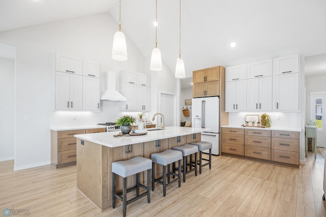 4295 Bristlecone Loop S, Fargo, ND 58104 - kitchen with premium range hood, high vaulted ceiling, white fridge with ice dispenser, a breakfast bar area, and a sink
