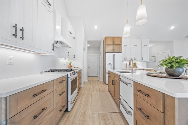 4295 Bristlecone Loop S, Fargo, ND 58104 - kitchen featuring white appliances, a sink, light wood-type flooring, light countertops, and hanging light fixtures