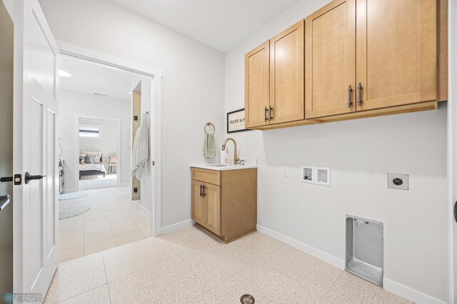 4295 Bristlecone Loop S, Fargo, ND 58104 - laundry area featuring electric dryer hookup, cabinet space, washer hookup, and baseboards