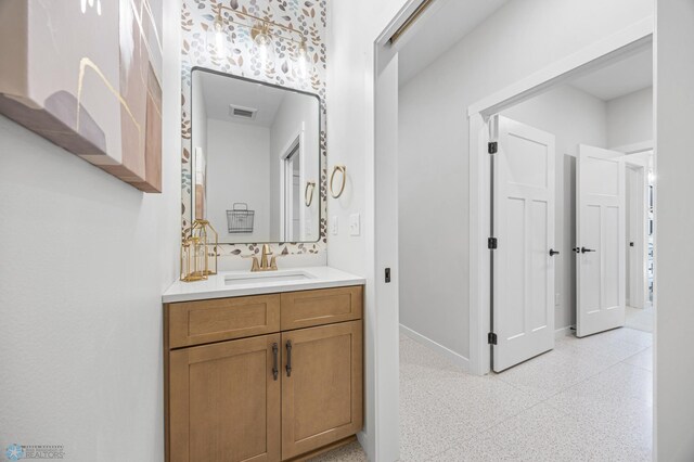 4295 Bristlecone Loop S, Fargo, ND 58104 - bathroom with speckle patterned floor, vanity, and baseboards