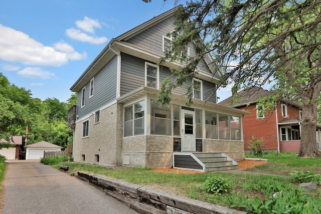 1807 Minnehaha Ave W, Saint Paul, MN 55104 - american foursquare style home with an outbuilding, a sunroom, and a detached garage