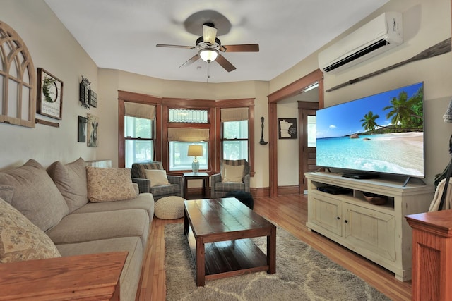 1807 Minnehaha Ave W, Saint Paul, MN 55104 - living area featuring an AC wall unit, a ceiling fan, and light wood-style floors