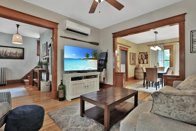 1807 Minnehaha Ave W, Saint Paul, MN 55104 - living room with an AC wall unit, light wood finished floors, ceiling fan, radiator, and a chandelier