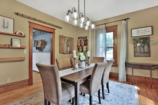 1807 Minnehaha Ave W, Saint Paul, MN 55104 - dining room featuring wood finished floors, baseboards, and a chandelier