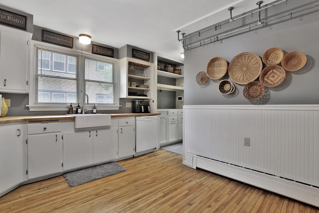 1807 Minnehaha Ave W, Saint Paul, MN 55104 - kitchen featuring a sink, dishwasher, light wood-type flooring, a baseboard heating unit, and white cabinetry