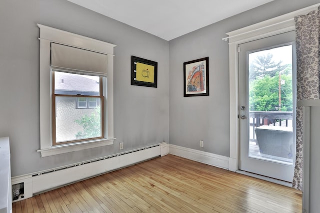 1807 Minnehaha Ave W, Saint Paul, MN 55104 - doorway to outside featuring a baseboard heating unit, plenty of natural light, and light wood-style floors